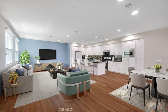 228 Borrego, Irvine, CA 92618 - living room featuring light wood-style floors and recessed lighting