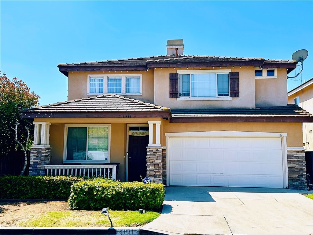 4911 Glickman Ave, Temple City, CA 91780 - view of front of house with stone siding, a garage, a porch, and concrete driveway