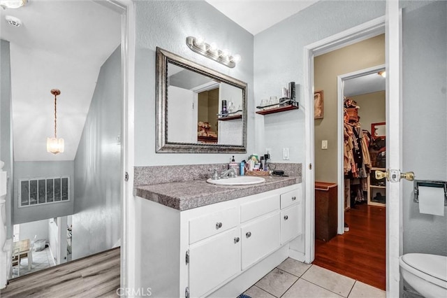 1523 Lynton Ave, Wilmington, CA 90744 - bathroom with vanity, toilet, tile patterned flooring, and a spacious closet