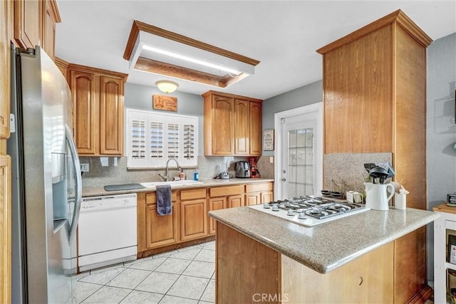 1523 Lynton Ave, Wilmington, CA 90744 - kitchen featuring white appliances, a sink, backsplash, a peninsula, and light tile patterned flooring
