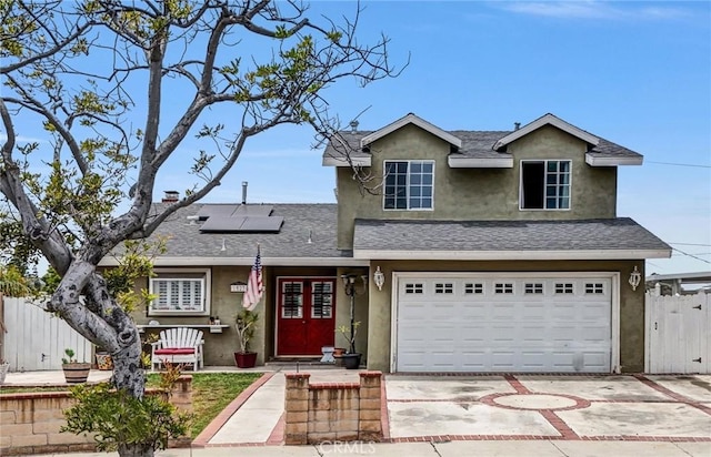 1523 Lynton Ave, Wilmington, CA 90744 - traditional home with stucco siding, driveway, solar panels, and an attached garage