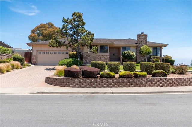 250 Coral Ct, Pismo Beach, CA 93449 - single story home featuring a chimney, stone siding, decorative driveway, and a garage