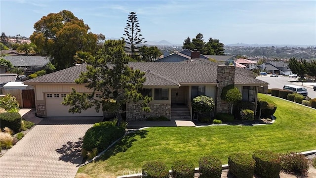 250 Coral Ct, Pismo Beach, CA 93449 - ranch-style house with stone siding, decorative driveway, an attached garage, a front lawn, and a residential view