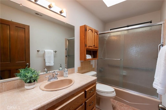 250 Coral Ct, Pismo Beach, CA 93449 - full bath with vanity, shower / bath combination with glass door, decorative backsplash, tile patterned floors, and a skylight