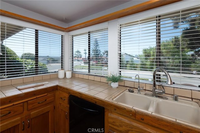 250 Coral Ct, Pismo Beach, CA 93449 - kitchen featuring tile countertops, black dishwasher, and brown cabinetry