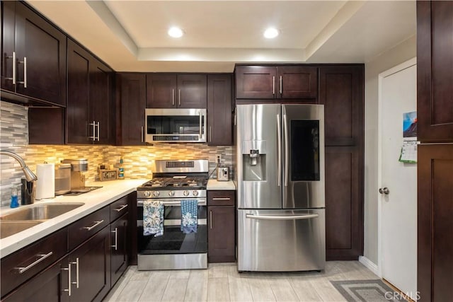 10546 Royal Oak Way, Stanton, CA 90680 - kitchen with appliances with stainless steel finishes, backsplash, light countertops, dark brown cabinets, and recessed lighting