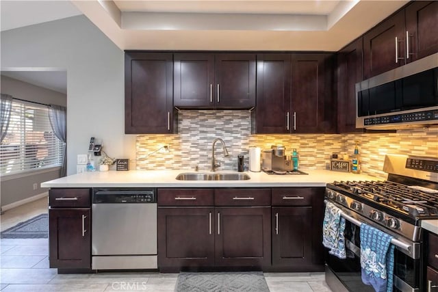 10546 Royal Oak Way, Stanton, CA 90680 - kitchen featuring stainless steel appliances, tasteful backsplash, light countertops, dark brown cabinets, and a tray ceiling