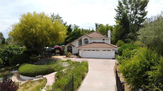 10830 Orchard View Ln, Riverside, CA 92503 - mediterranean / spanish-style house with a chimney, concrete driveway, an attached garage, a tile roof, and stucco siding