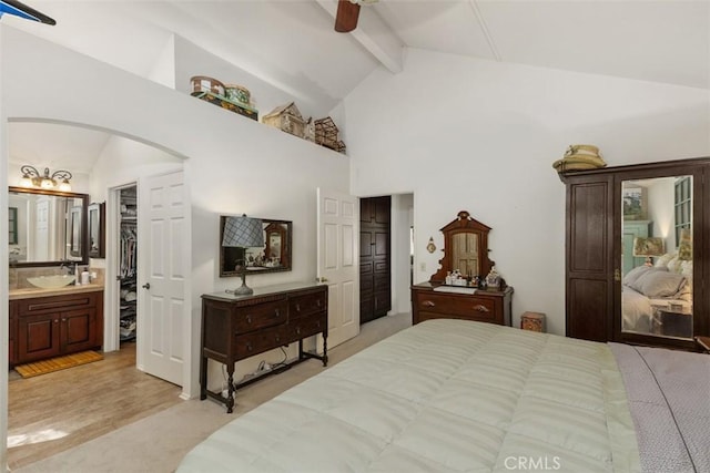 10830 Orchard View Ln, Riverside, CA 92503 - bedroom with arched walkways, beamed ceiling, connected bathroom, high vaulted ceiling, and a sink