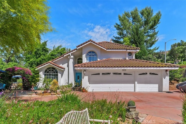 10830 Orchard View Ln, Riverside, CA 92503 - mediterranean / spanish-style house with stucco siding, a tiled roof, concrete driveway, and a garage