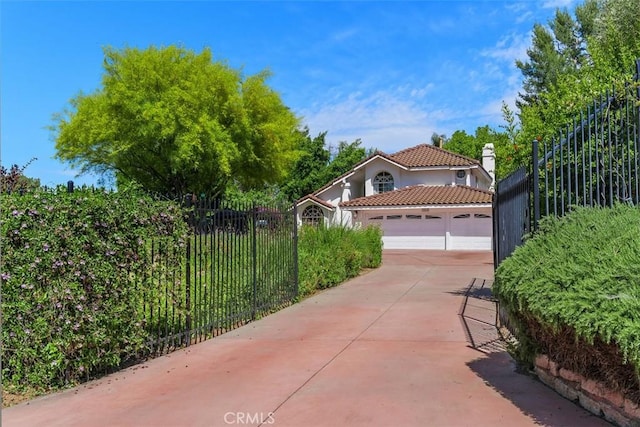 10830 Orchard View Ln, Riverside, CA 92503 - view of front of property featuring driveway, a garage, a tiled roof, a chimney, and stucco siding