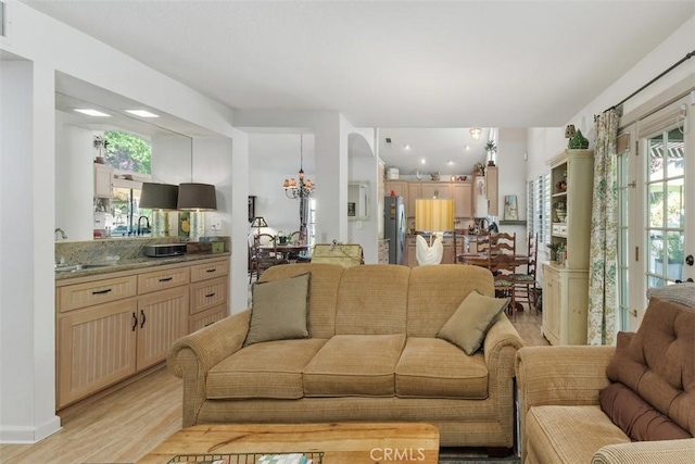10830 Orchard View Ln, Riverside, CA 92503 - living room with light wood-style flooring, plenty of natural light, and a chandelier