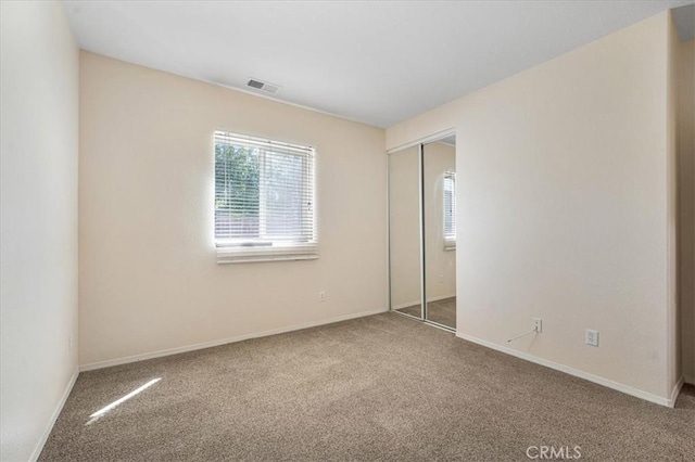 36340 Sicily Ln, Winchester, CA 92596 - unfurnished bedroom featuring multiple windows, carpet flooring, and a closet