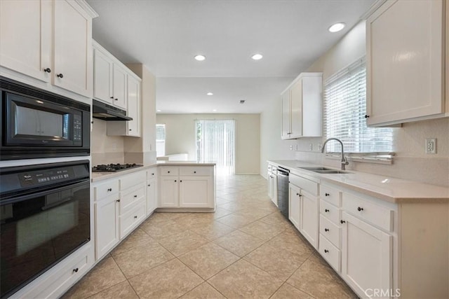 36340 Sicily Ln, Winchester, CA 92596 - kitchen with black appliances, a peninsula, light tile patterned flooring, light countertops, and white cabinets