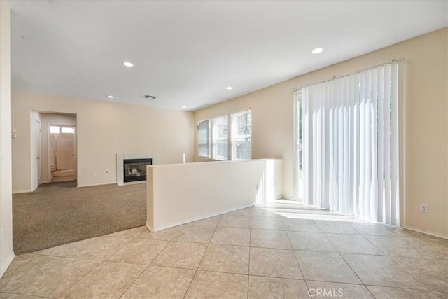 36340 Sicily Ln, Winchester, CA 92596 - spare room with healthy amount of natural light, a tiled fireplace, light tile patterned flooring, and recessed lighting