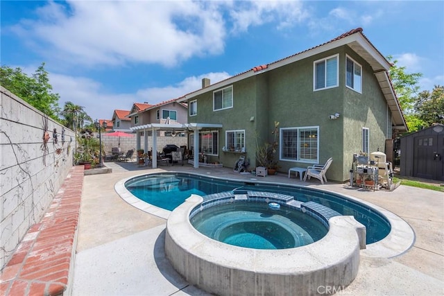 9081 Mandarin Ln, Riverside, CA 92508 - view of swimming pool with a pergola, a pool with connected hot tub, a patio area, and a fenced backyard