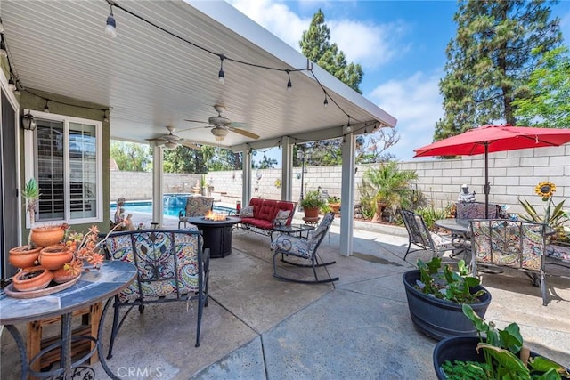 9081 Mandarin Ln, Riverside, CA 92508 - fenced backyard featuring a fire pit, a ceiling fan, a patio, and outdoor dining area