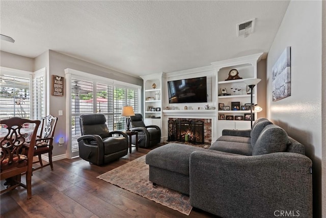 9081 Mandarin Ln, Riverside, CA 92508 - living area with dark wood-style flooring, a lit fireplace, a textured ceiling, and baseboards