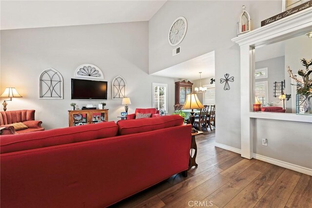9081 Mandarin Ln, Riverside, CA 92508 - living area with baseboards, hardwood / wood-style floors, a towering ceiling, and a chandelier