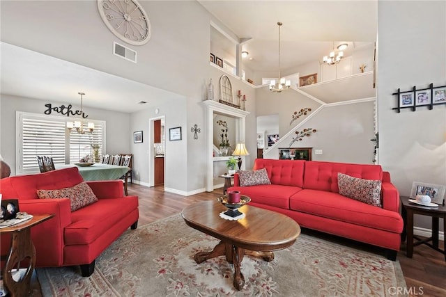 9081 Mandarin Ln, Riverside, CA 92508 - living room featuring a chandelier, wood finished floors, baseboards, and a towering ceiling