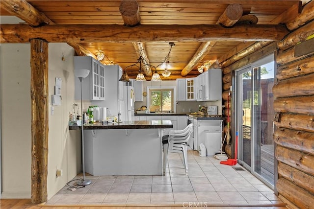 30771 Fox Ridge Ct, Tehachapi, CA 93561 - kitchen featuring rustic walls, a peninsula, dark countertops, wood ceiling with exposed beams, and glass insert cabinets