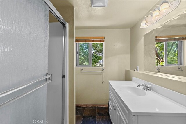30771 Fox Ridge Ct, Tehachapi, CA 93561 - full bath featuring vanity, stone tile floors, baseboards, and an enclosed shower