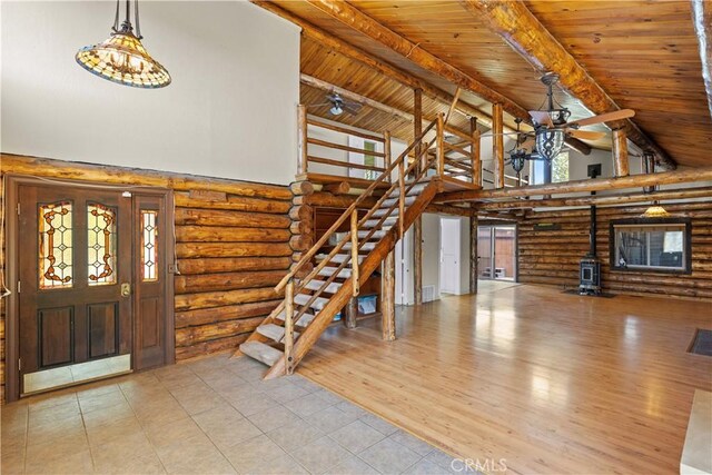 30771 Fox Ridge Ct, Tehachapi, CA 93561 - tiled foyer with log walls, high vaulted ceiling, a ceiling fan, a wood stove, and wood ceiling with exposed beams