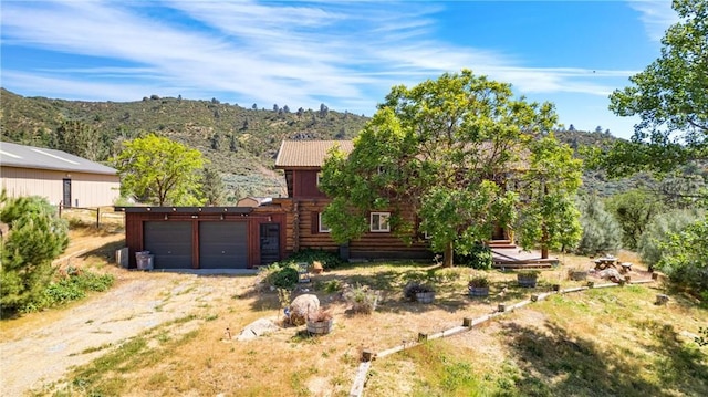 30771 Fox Ridge Ct, Tehachapi, CA 93561 - view of front of property with an attached garage, a mountain view, and dirt driveway