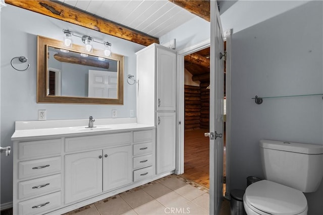 30771 Fox Ridge Ct, Tehachapi, CA 93561 - bathroom with beamed ceiling, vanity, toilet, and tile patterned floors
