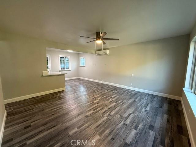 2911 Rancho Vista Dr, Lucerne, CA 95458 - spare room with ceiling fan, dark wood-type flooring, an AC wall unit, and baseboards