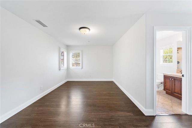15 Basilica Pl, Ladera Ranch, CA 92694 - empty room featuring plenty of natural light, dark wood-style floors, and baseboards