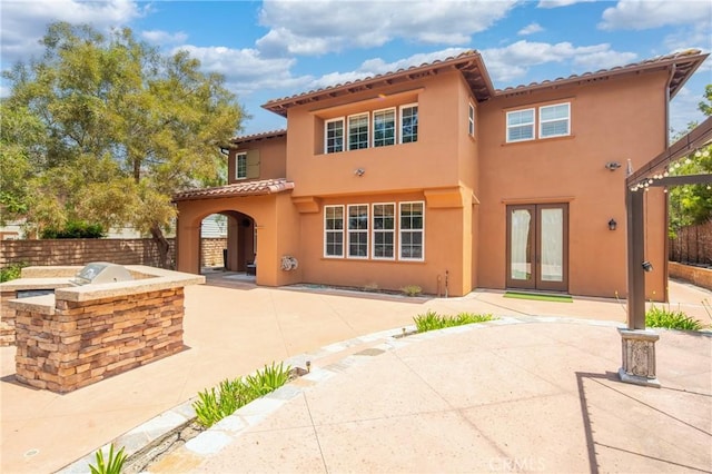 15 Basilica Pl, Ladera Ranch, CA 92694 - back of house with area for grilling, french doors, a patio area, stucco siding, and a tiled roof