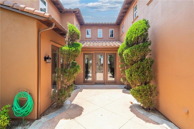 15 Basilica Pl, Ladera Ranch, CA 92694 - doorway to property with french doors, stucco siding, and a tile roof