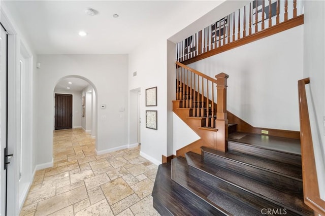 15 Basilica Pl, Ladera Ranch, CA 92694 - foyer with stone tile floors, baseboards, arched walkways, recessed lighting, and stairs