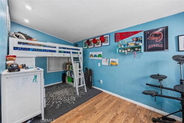 4201 Irvon Trl, Frazier Park, CA 93225 - bedroom featuring wood finished floors, vaulted ceiling, and baseboards