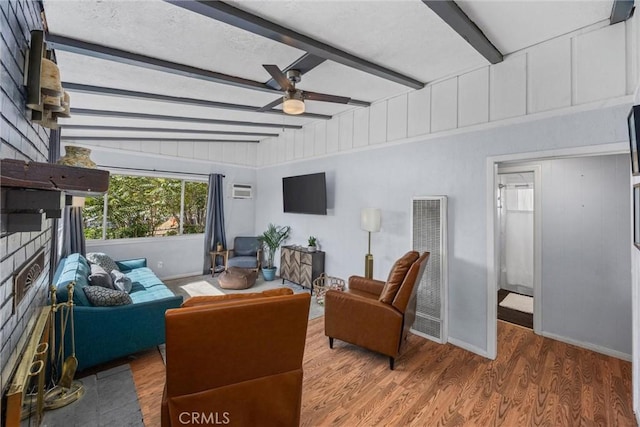 4201 Irvon Trl, Frazier Park, CA 93225 - living area with a heating unit, a ceiling fan, beamed ceiling, wood finished floors, and baseboards