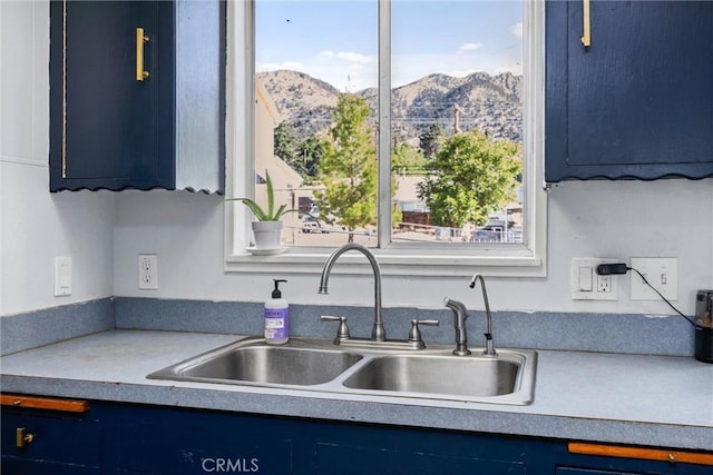 4201 Irvon Trl, Frazier Park, CA 93225 - kitchen with blue cabinetry, a sink, a mountain view, and light countertops