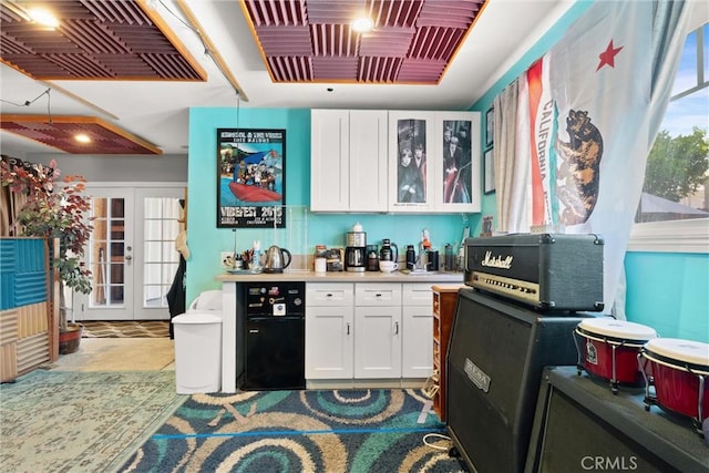 234 N Alta Vista Ave, Monrovia, CA 91016 - kitchen with white cabinetry, glass insert cabinets, light countertops, and french doors