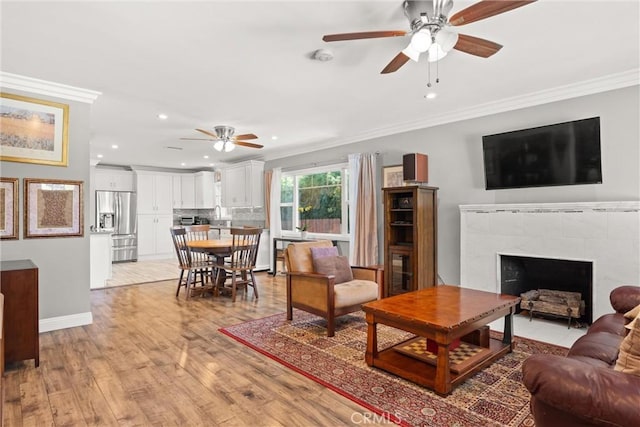 234 N Alta Vista Ave, Monrovia, CA 91016 - living area featuring a ceiling fan, ornamental molding, recessed lighting, light wood finished floors, and a tiled fireplace