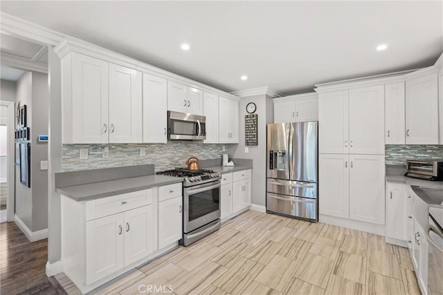 234 N Alta Vista Ave, Monrovia, CA 91016 - kitchen with appliances with stainless steel finishes, tasteful backsplash, white cabinetry, and recessed lighting