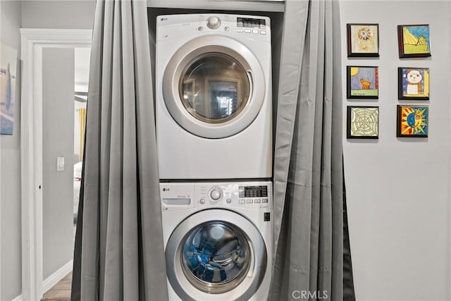 234 N Alta Vista Ave, Monrovia, CA 91016 - washroom featuring stacked washing machine and dryer and wood finished floors