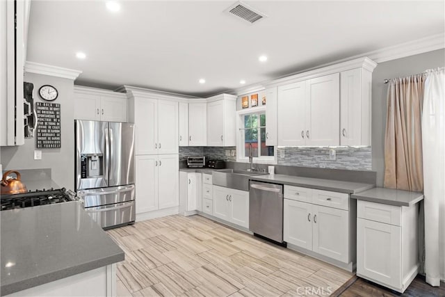 234 N Alta Vista Ave, Monrovia, CA 91016 - kitchen with appliances with stainless steel finishes, crown molding, decorative backsplash, white cabinets, and recessed lighting