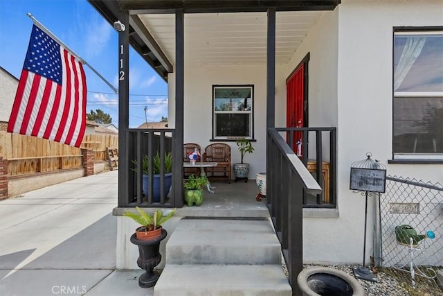 112 W Grandview Dr, Barstow, CA 92311 - doorway to property featuring stucco siding and a porch
