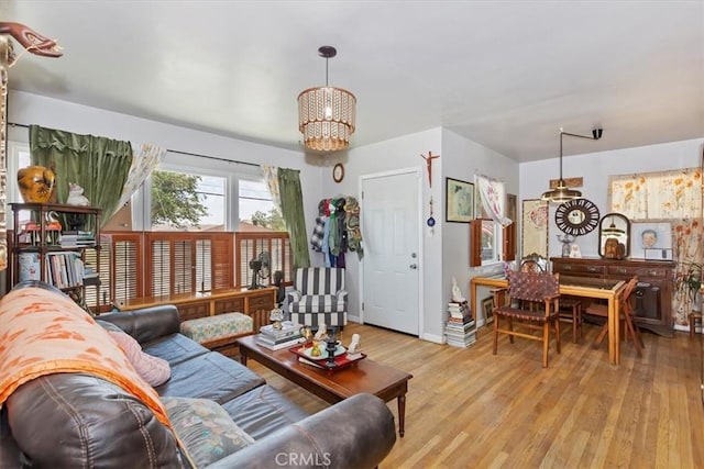 112 W Grandview Dr, Barstow, CA 92311 - living area with light wood finished floors, a chandelier, and baseboards