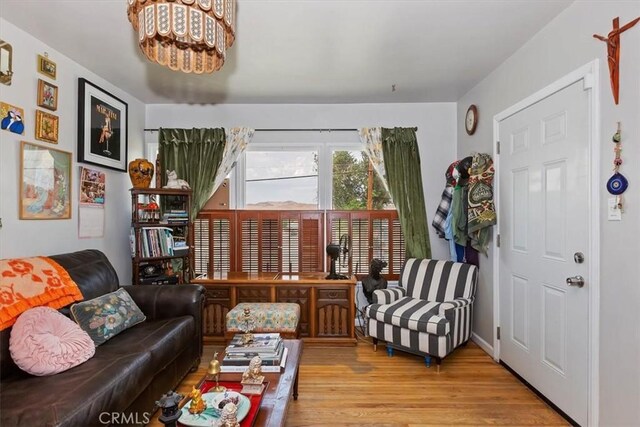112 W Grandview Dr, Barstow, CA 92311 - living room featuring wood finished floors and a chandelier