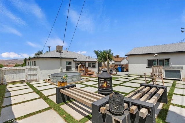112 W Grandview Dr, Barstow, CA 92311 - back of property with a fire pit, a patio area, a gate, and stucco siding