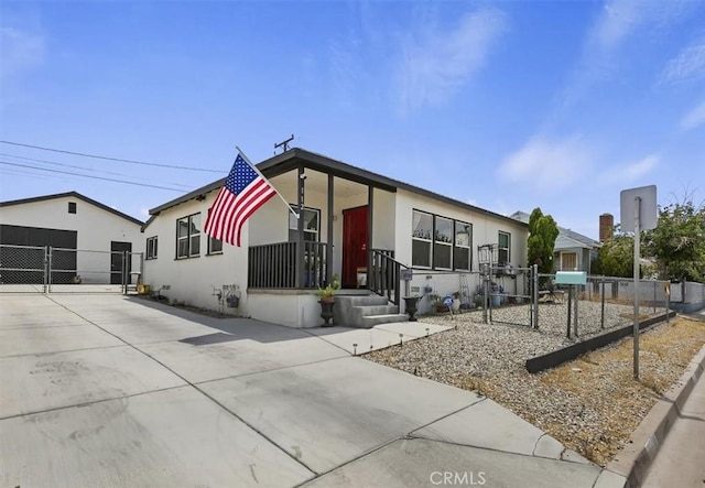 112 W Grandview Dr, Barstow, CA 92311 - view of front of house with a gate, stucco siding, and concrete driveway