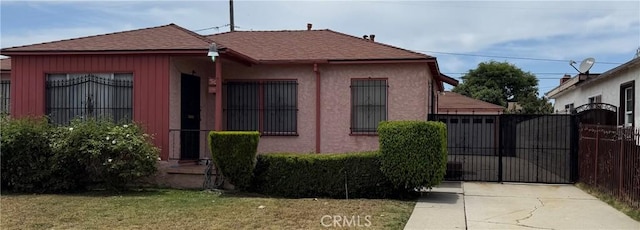 1201 S Exmoor Ave, Compton, CA 90220 - bungalow featuring roof with shingles, a gate, and stucco siding