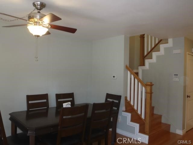 11459 Shippigan Way, Cypress, CA 90630 - dining room with a ceiling fan, stairs, wood finished floors, and baseboards