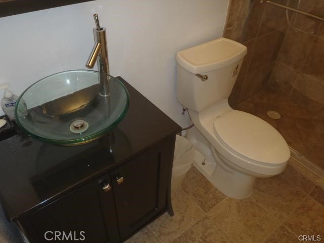 11459 Shippigan Way, Cypress, CA 90630 - bathroom with toilet, vanity, and a tile shower